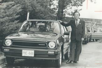 Holding the line on price: Masayoshi Tsukamoto, president of Honda of Canada, shows off a 1980 Civic at yesterday's press preview