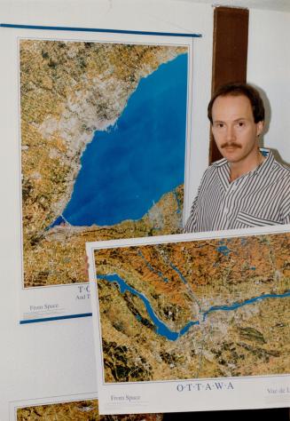 Overhead shot: Robert Stacey shows off posters of the Golden Horseshoe and the Ottawa area, made by his company from photos taken 705 kilometres (405 miles) up