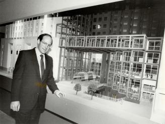 King st. atrium: David Stewart, vice-president of Campeau Corp., shows off huge model of the King St. entrance to the Scotia Plaza tower. he says we are trying to look ahead to the end of this century with our building design. It will offer completely computer-controlled lighting, heating, air conditioning and power.
