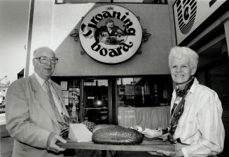 Hearty fare: Fred and Jean Stinson, owners of The Groaning Board Restaurant, stand outside the establishment with an assortment of goodies