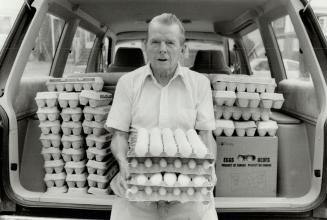 Egg man: Robert Strickland, 70, displays some of the 200 dozen eggs he delivers each week