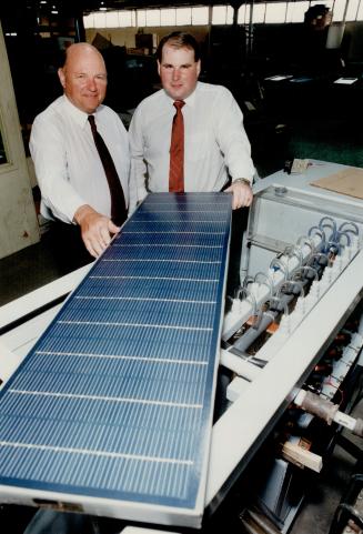Fuel source: Alexander Stuart, left, and his son, Andrew, display a solar panel and electrolysis unit which they hope to combine to produce hydrogen.