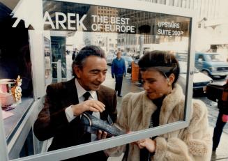 Upscale emporium: Marek Sutkiewicz and his daughter Irit Shay discuss merchandise from the street-level showcase of Sutkiewicz' new luxury gift store on Bloor St