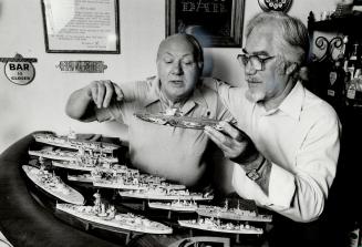 Catching up on old times: Dr. Tony Sweeting, left, and Jim Doolan, re-united for the first time since World War II, hold a model of HMS Indomitable, their aircraft carrier.