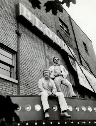 Big at the reps: Repertory cinema entrepreneurs Tom Litvinskas and Jerry Szczur pose on top of the marquee at the Bloor Cinema, the flagship of their one-night-showing movie-house chain