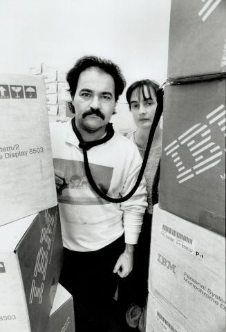 Locked in: Cosmo Tagliafierro of North York, with his wife Lucy, is so angry about paying $50,000 in cash for 10 computers in the Food Court scheme that he insisted on tying himself to them for this photo