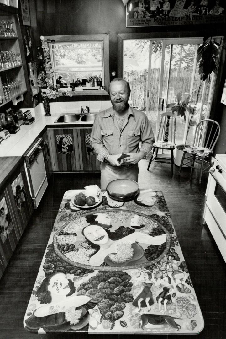 Focal point: Art gallery owner Bernie Taylor works in his kitchen, above, with Duncan Phyfe drop-leaf table, painted with primitive folk art.