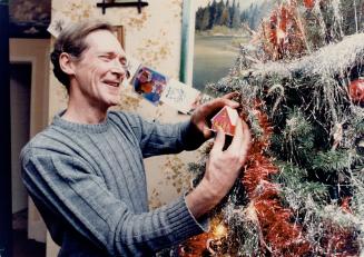 Season of hope: John Taylor admires Christmas tree his mother leaves up year-round