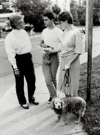 On the hunt: Rico Tisi takes a break from posting lost-dog signs to talk to fellow dog owner Karin McPherson, right, and Ingrid Noth