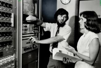 Video teacher: Paul Thompson, a professor at the University of Toronto's Scarborough campus, and Janis Wood, from the campus' registration office, look at some of the equipment used in video teaching
