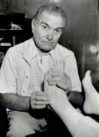 Playing footsie with patients. Reflexologists claim they can heal by stimulating nerves in feet