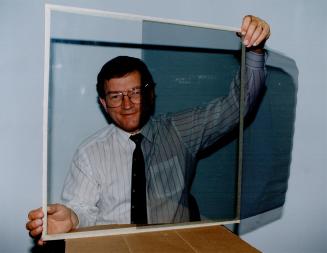 Hot stuff: George Turjanica demonstrates a heatcutting window film which is sold by his firm.
