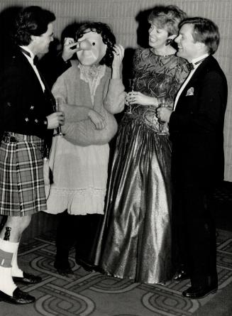 Above, George Thomson, in the Thomson kilt, tweaks the nose of Mime Unlimited's Linda Carter while teacher Mary Davie, in bronze net, and Senator Michael Kirby look on