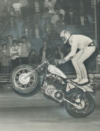 Star-Spangled Stuntman Evel Knievel (born Robert Craig Knievel) warms up Thursday night at Buffalo's Lancaster Speedway for one of his spectacular 100-mile-an-hour-plus leaps through space atop his motorcycle