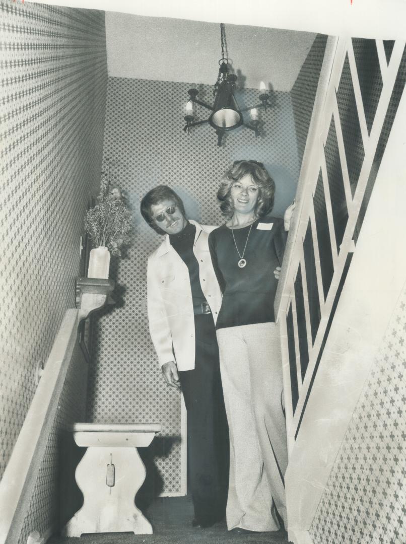 Canadian Golf Pro George Knudson, spokesman for the 496-suite development which Overlooks the sprawling Markland Wood Country Club, is shown above with his wife in the entry way to a two-storey, three-bedroom apartment