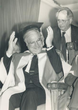 Tipsy mortarboard: West German Chancellor Helmut Kohl, left, is aided by interpreter Heinz Weber at Convocation Hall where he received an honorary degree