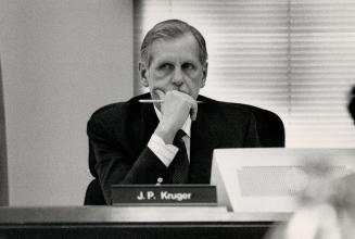 Back on job: John Kruger, car insurance board chairman, listens at hearings on no-fault insurance yesterday after his board's rate decision was overruled