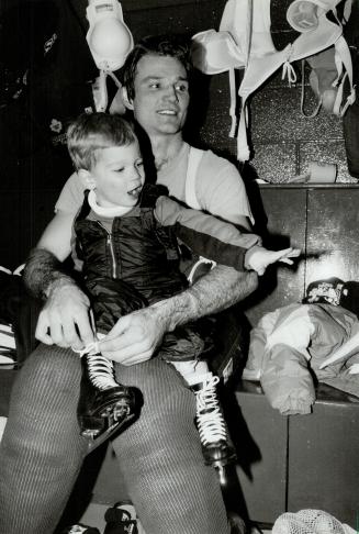 Hurry up, dad: Three-year-old Alexander Krushelnyski gets some help with his laces from good ol' dad, Mike, after Leafs practice yesterday at the Gardens