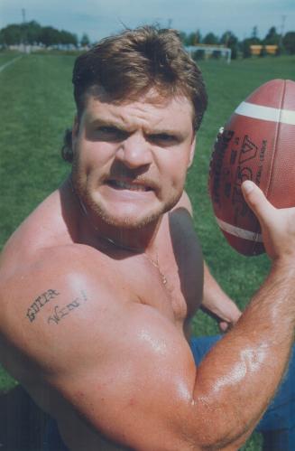 Tough stance: 'Gotta WIn' is the message tattooed on the bulging shoulder of Argonaut player Glenn Kulka