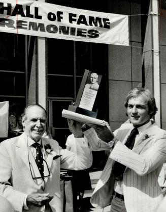 Honored Montreal Canadiens' star Guy Lafleur accepts the Lou Marsh Trophy as Canada's outstanding athlete of 1977 from committee chairman Harry Red Foster