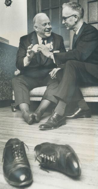 Allan Lamport's aching feet get a break in campaign. He's offered a sandwich by his host, Murray Forfar of Garden Ave.