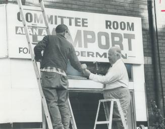 In politics since 1937, Controller Allan Lamport helps put up the sign on his new campaign head-quarters and finds his name misspelled
