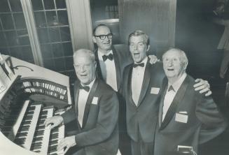 Singing the old songs to mark a half-century of community service by the Kiwanis Club of West Toronto, Horace Lapp plays the organ for vocalists, from left: Ted Johnson, of Denver, Col