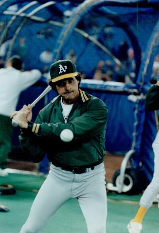 On the ball: Oakland A's manager Tony La Russa hits a little infield before last night's Game 2 encounter with the Blue Jays in AL playoff action at SkyDome