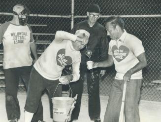 Gunga Din: Official water boy for North York Council's super softball team was Controller Irving Paisley at a benefit game yesterday against Willowdale Softball League officials
