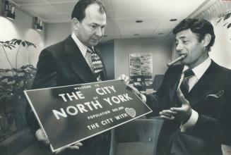 Controller Robert Yuill shows mock-up of North York's new boundary signs to Mayor Mel Lastman.