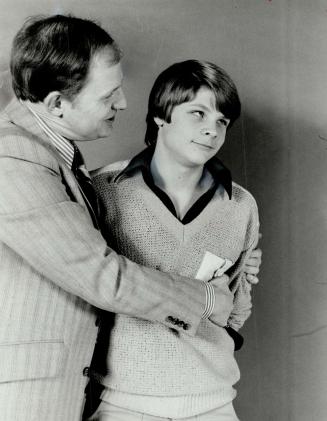 Gary Lautens and his 14-year-old son Richard hug. Richard looks a bit reluctant, don't you agree?