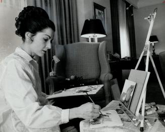 Another side of Carol Lawrence's life is shown here in her hotel room where she spreads her artist's equipment out and paints to fill her spare time in a constructive way while away from home