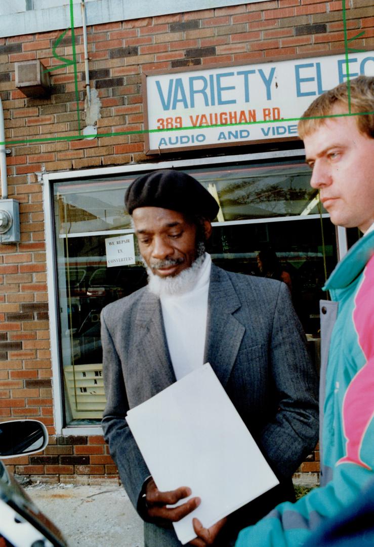 Dudley laws: Community activist is led away after his arrest on Immigration charges at a Vaughan Rd. office.