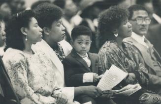 A memorial: The family of Wade Lawson listens to The Chosen Generation choir, below, at a service yesterday