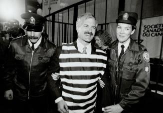 Headed for slammer: Mayoral candidate Jack Layton is 'arrested' by Constables Frank Bergen and Cary McNair at a Cancer Society fundraiser yesterday