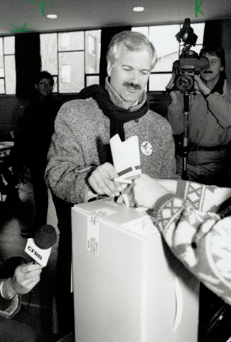 One for Jack: Mayoral candidates Jack Layton deposits his ballot during voting yesterday morning at Ogden School on Phoebs St