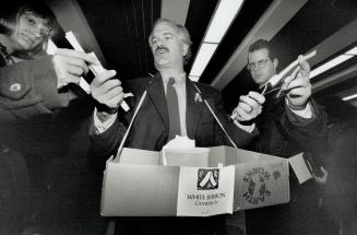 Ribbons of hope: Former mayoral candidates Jack Layton hands out white ribbons at Union Station today.