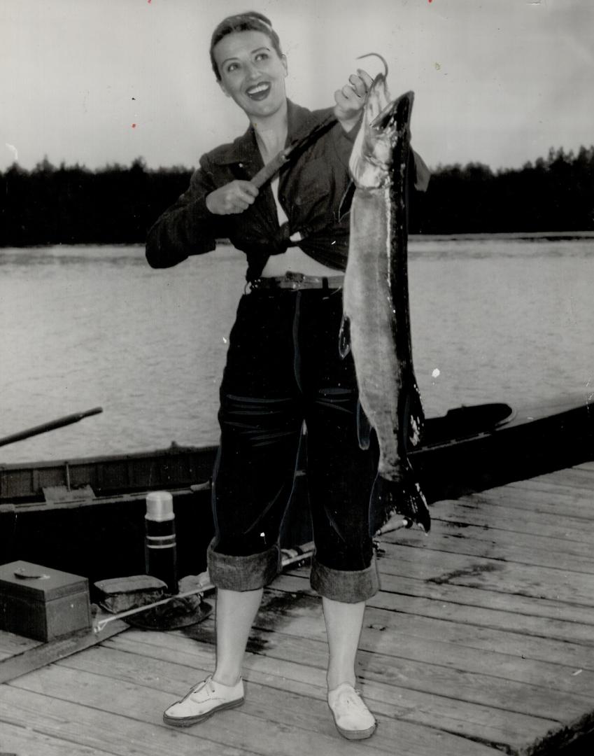 One that didn't get away, a whopping musky, is proudly displayed by Gypsy Rose Lee who landed it during her vacation in Wisconsin at Sturgeon Bay