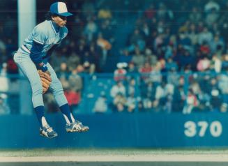 Young Manny Lee leaps and makes this play early in yesterday's game at Detroit but the ground ball he couldn't come up with in the 12th Inning cost the Jays 3-2 win