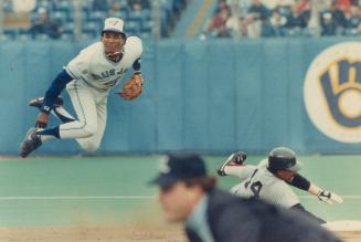 Leapin' Lee: Bruce Jays second baseman Manny Lee acrobatically avoids a hard-sliding Jim Rice of the Red Sox in the fourth inning yesterday and relays the ball to first base to complete a 6-4-3 double play