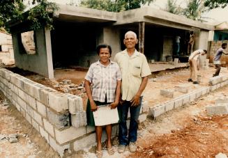 The house Manny built: Lee's mother Ana Carolina stands on the threshold of the old family home, while (inset) father Lara Sanchez joins her on the site of the new house - under construction courtesy of Manny