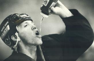 A thirst for goals?: Leafs right winger Gary Leeman takes a healthy gulp of water during a recent practice.