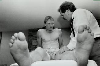Bigfoot gets physical: Gary Leeman gets an okay from Dr. Michael Easterbrook as the Leafs went through their usual physical checkups at Maple leaf Gardens yesterday.
