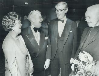This year's good servant, honored by the Canadian Council of Christians and Jews, Betty Jones and her husband, Richard, are congratulated by Governor-General Jules Leger last night after a 1,100 guest banquet at the Royal York Hotel at which Mrs