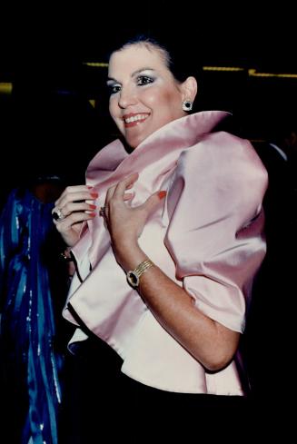 Co-chair of the Opera Ball Catherine Leggett, above, wears an eye-catching pastel pink satin jacket with high collar and puffed sleeves over a slim black velvet strapless gown
