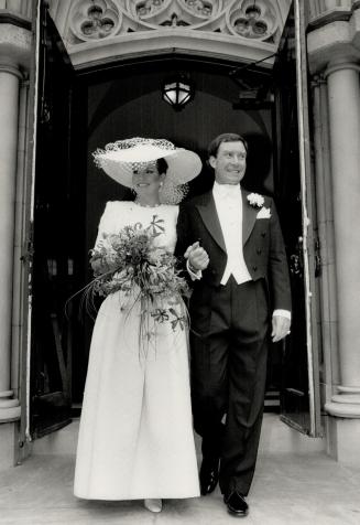 Left, the bride, Catherine Leggett, wearing a Nina Ricci gown, and groom, David Nugent, emerge from St. Paul's Cathedral.