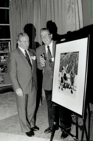 Famous photo: Scotty Morrison (left) and Frank Lennon with Lennon's photo of the celebration following Paul Henderson's big goal against the Soviets in '72