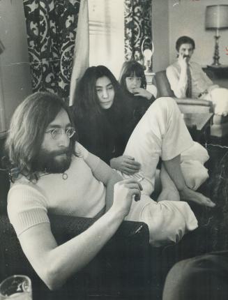 After a hard day's night at Toronto airport, while immigration officers debated for two hours whether to let them enter Canada, Beatle John Lennon, his wife Yoko and daughter Kyoko, 5 sit in peace in hotel room today