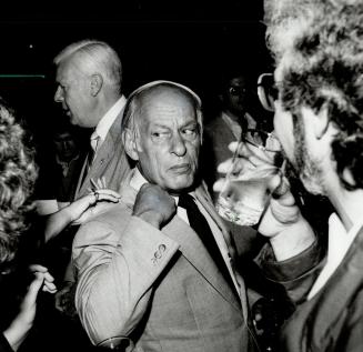 Collared: Quebec Premier Rene Levesque reacted quickly when he felt a hand on his collar during a reception during the premiers' conference in Toronto last night