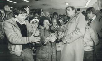 Rosy celebration: Gisella Confino-Levi, the flower lady of the Wellesley subway station, celebrates Immigration Minister Lloyd Axworthy's decision to let her stay in Canada with Allan Firsten (left), president of the Cash-N-Carry flower market, and Toronto Mayor Art Eggleton, who gave her a box of chocolates